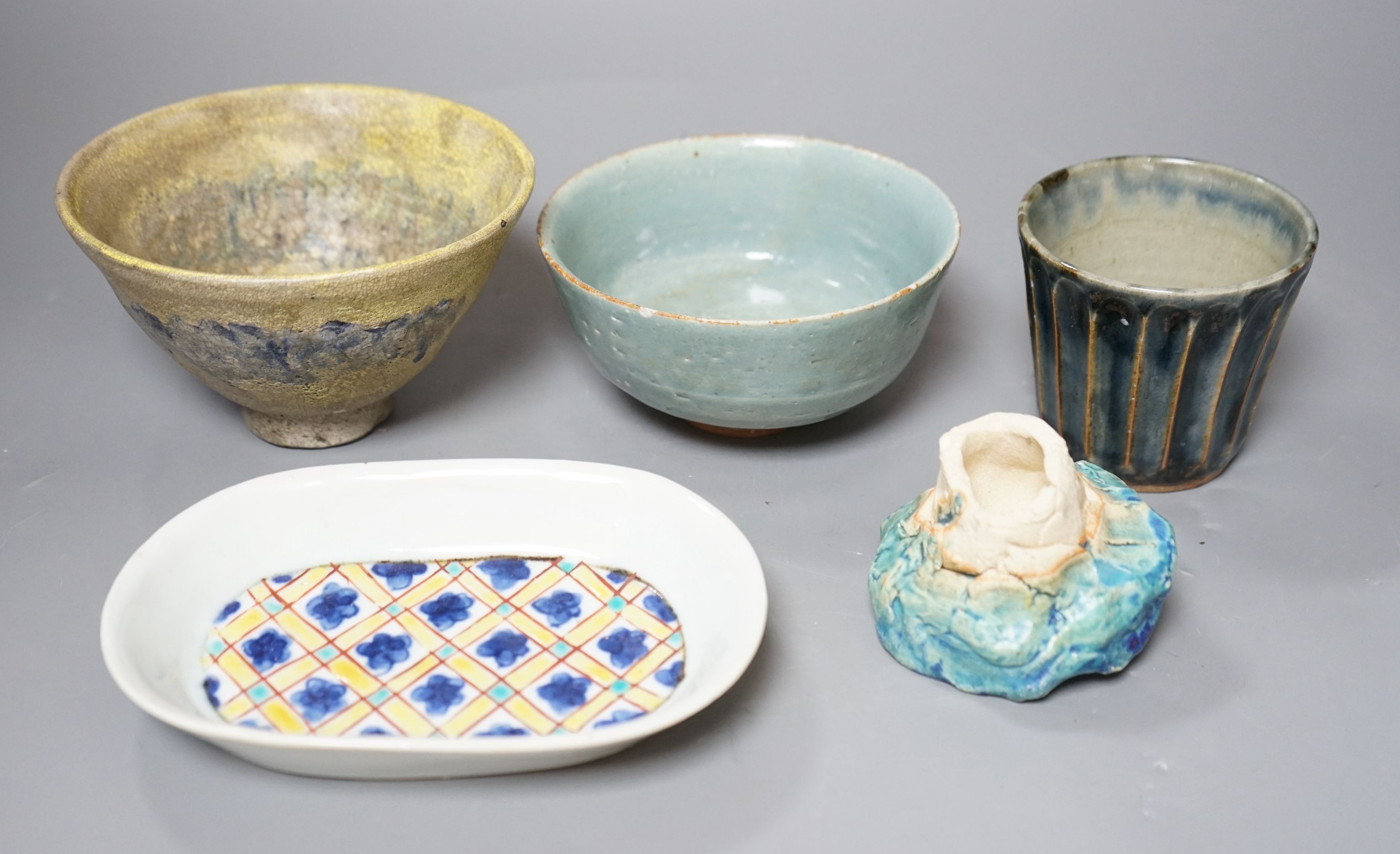 Japanese studio pottery; a group to include two bowls, and a plum dish, a fluted cup and a brushwasher, tallest 8cm, (5)